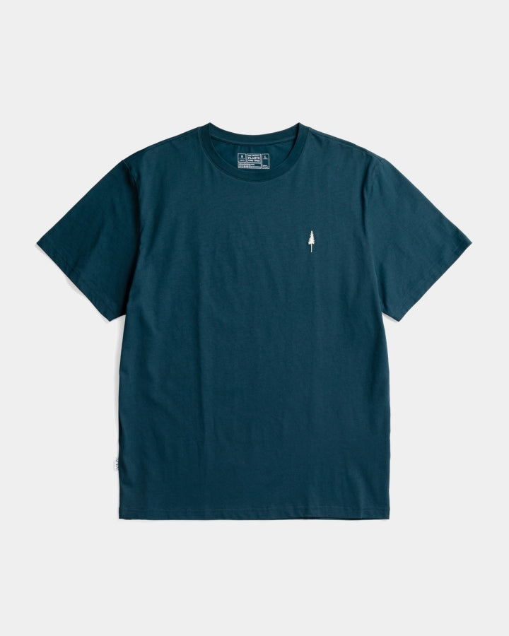 The Essential Kit TreeShirt in plain dark teal features short sleeves and a small white arrow graphic on the left chest, shown on a white background.