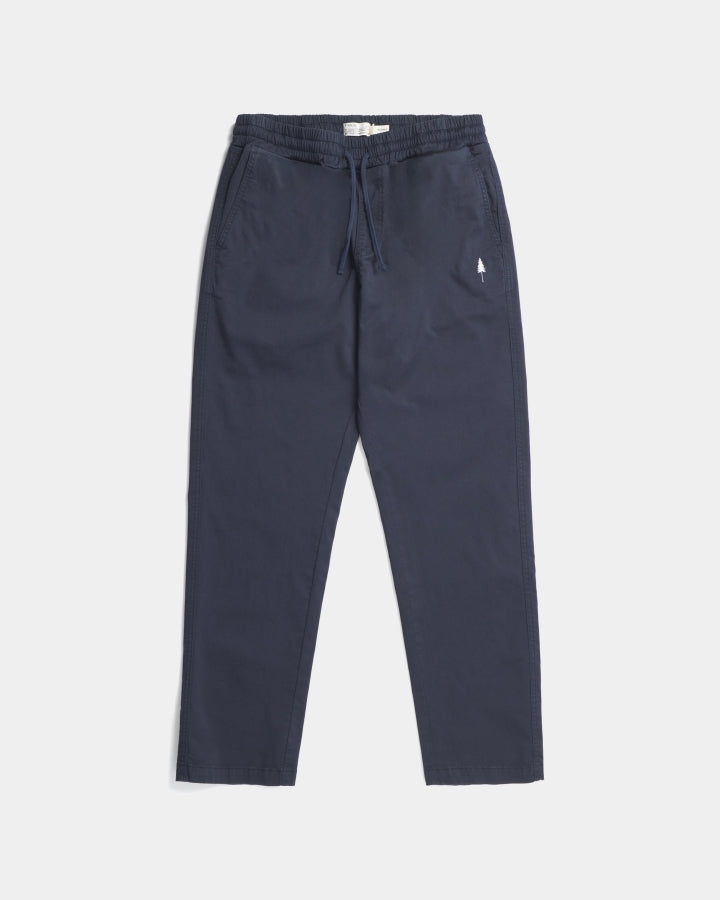 The Urban Explorer TreePants in navy blue feature a drawstring waist, side pockets, and a small white tree logo on the left thigh—laid flat on a white background, ideal for outdoor adventures.
