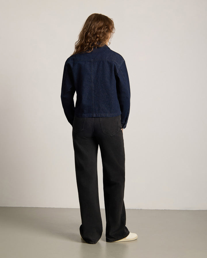 NIKIN TreeJacket Denim ReCotton Damen, Dunkelindigo, Damenjacke aus Baumwollmischung, lange Haare, weißer Wandhintergrund.